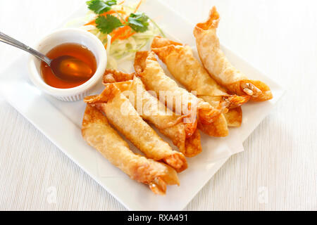 Angolo di alta vista di avvolgere i gamberi fritti con salsa e insalata servita nella piastra sulla tabella Foto Stock