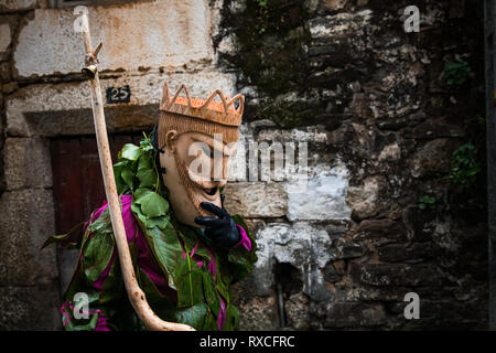 Un attenzione visto sfilare attraverso le strade durante il carnevale. Considerato uno dei più tipici festeggiamenti carnevaleschi del paese, nel villaggio di Lazarim, nel comune di Lamego, il caretos (mascherata partecipanti) sfilano per le strade in una manifestazione ancestrale di scene di cultura portoghese. Foto Stock