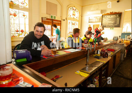 I lavoratori con un drink in un pub dopo il lavoro. Foto Stock