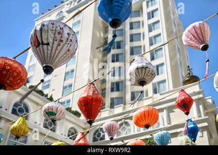 Righe di appendere colorate lanterne cinesi sui cavi sullo sfondo di edifici. È la celebrazione del nuovo anno lunare in Nha Trang in Vietnam. Foto Stock
