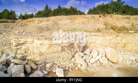La vista della foresta accanto alla zona delle cave. Ci sono un sacco di alberi verdi sulla foresta con la cava di calcare area sulla parte inferiore Foto Stock