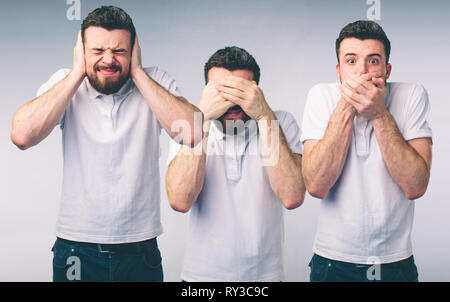 Isolato studio shot di una donna caucasica nel vedere alcun male, non sento, non parlo pone Foto Stock