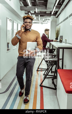 Elegante African American uomo in maglia maglione parlando al telefono cellulare Foto Stock