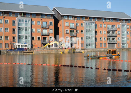 Bloccare le riparazioni e dragaggio presso il bacino principale di Gloucester Docks nell Inghilterra del sud Foto Stock