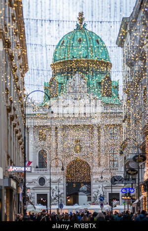 Sistemazione di Kohlmarkt con il Palazzo di Hofburg alla parte posteriore, nel centro di Vienna dopo il buio, Austria. Foto Stock