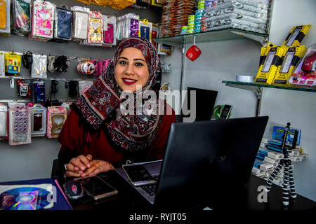 Hanna Elyan e suo fratello hereth eseguire un telefono cellulare negozio di accessori in Jalazone Refugee Camp vicino a Ramallah in Cisgiordania, Palestina. Ha preso in prestito $ 5 Foto Stock