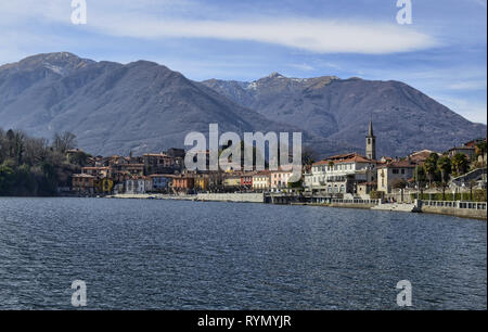 Mergozzo, Piemonte, Italia. Marzo 2019. Vista del paese che si affaccia sulle calme acque del lago. Le facciate con la loro calorosa e colori luminosi stan Foto Stock