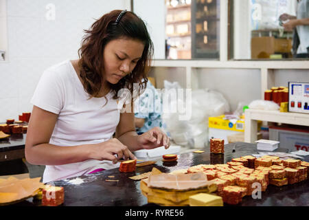 I lavoratori creano la foglia di oro al Re Galon foglia oro workshop a Mandalay, Myanmar Foto Stock