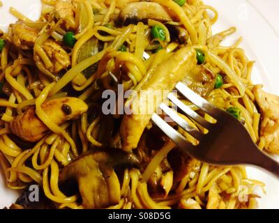 Pollo Chow Mein servita su una piastra bianca Foto Stock