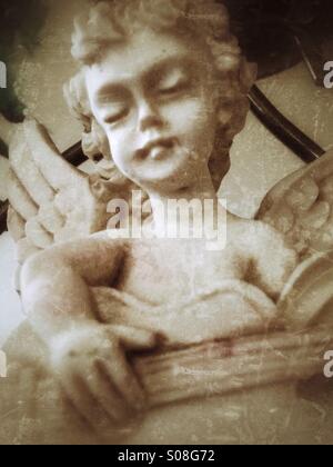 Un cherubino di suonare una chitarra. Foto Stock