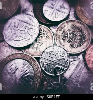 Uno sfondo di monete Britanniche con grunge filtri applicati Foto Stock