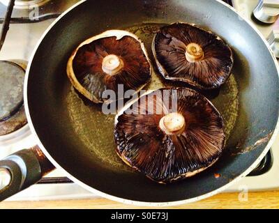 Funghi champignon essendo soffritto Foto Stock