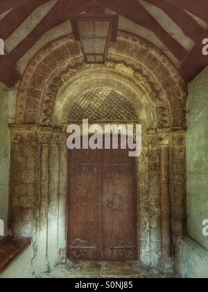 Porta della chiesa e Arco Normanno nel portico a St Giles & Tutti i Santi, Orsett, Essex. Foto Stock