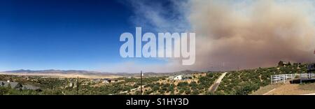 Panoramica della gamma della montagna lungo il Prescott Valley in Northern Arizona durante un wildfire sparando a fumo verso il cielo Foto Stock