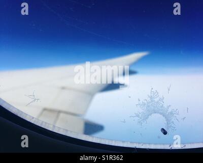 I cristalli di ghiaccio che si formano sulla finestra di un aereo Foto Stock