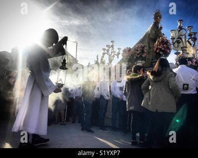 Un chierichetto si sparge incenso durante una processione della Madonna del Carmelo in Prado del Rey, Sierra de Cadice, Andalusia, Spagna Foto Stock
