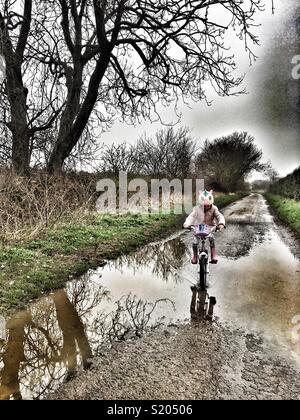 A cavallo di una pozzanghera Foto Stock