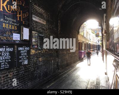 Persone che camminano giù il Kings Head Yard a Londra in Inghilterra Foto Stock