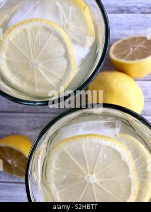 Vista dall'alto di due di ghiaccio freddo bicchieri di limonata su un tavolo di legno Foto Stock
