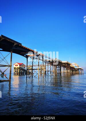 Vecchio Mumbles scialuppa di salvataggio station incorniciato da Mumbles pier con la nuova stazione di salvataggio alla fine, Swansea, South West Wales. Foto Stock