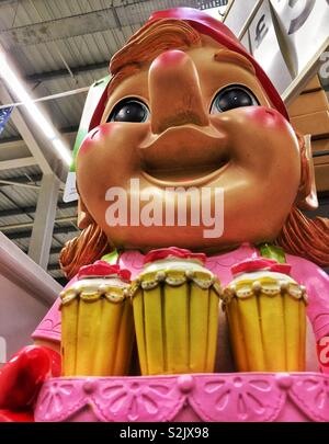 Cerca fino alla faccia di una grande e colorata gnomo da giardino che trasportano gelati sundaes in un supermercato. Foto Stock