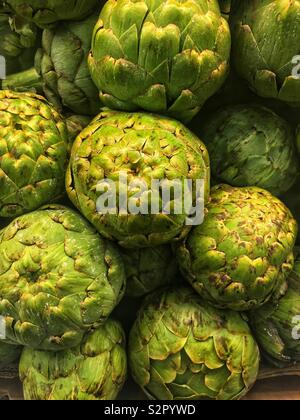 Telaio completo di deliziosi piatti freschi maturi verde crudo i carciofi. Foto Stock