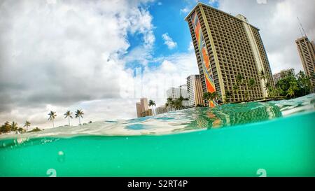 L'Hilton Hawaiian Village in Waikiki come si vede dall'oceano con split prospettiva. Foto Stock