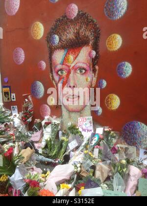 David Bowie santuario di fronte a un muro murale di lui. Brixton 2016. Foto Stock