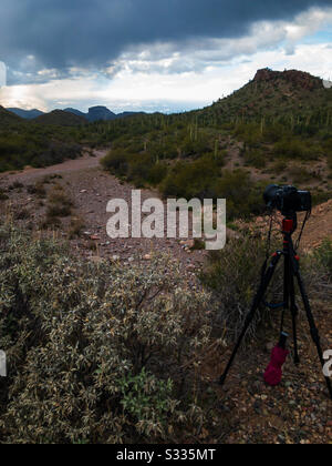 Una fotocamera digitale su un treppiede ha puntato su un suggestivo paesaggio desertico in un pomeriggio nuvoloso. Foto Stock