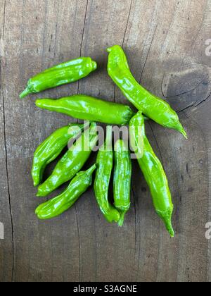 Peperoni freschi su una tavola di legno Foto Stock