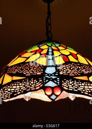 Lampada da soffitto in vetro colorato stile Tiffany con design multicolore a libellula Foto Stock