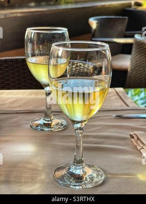 Due bicchieri di vino bianco fresco su un tavolo in un ristorante sul tetto Foto Stock