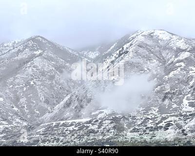 Le nuvole si stanno abbassando sulle Wasatch Mountains appena ad est della valle di Salt Lake nello Utah, Stati Uniti. Foto Stock