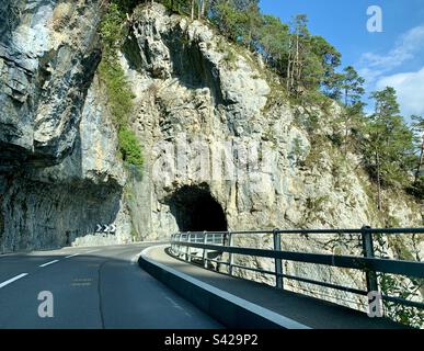 Strada in Svizzera che conduce al tunnel di montagna Foto Stock