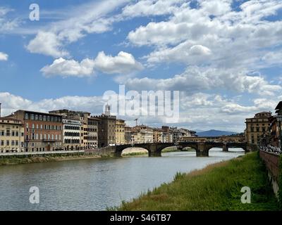 Fiume Arno, centro storico di Firenze, Italia. Il ponte Santa Trinità in primo piano è il più antico ponte ad arco ellittico, e dietro di esso uno scorcio degli edifici che costeggiano il ponte Vecchio Foto Stock