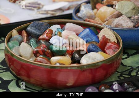 Colorata semi-pietre preziose e gemme in una ciotola rotonda Foto Stock