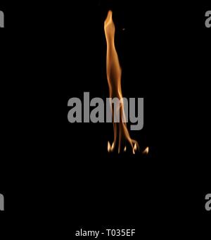 Le fiamme da una torcia ardente rising dritto in alto con fiamme più piccole in corrispondenza della sua base, contro uno sfondo scuro Foto Stock