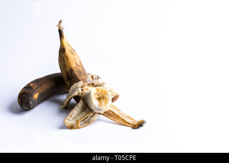 Due surmature annerite brutto banane su sfondo bianco. Foto Stock