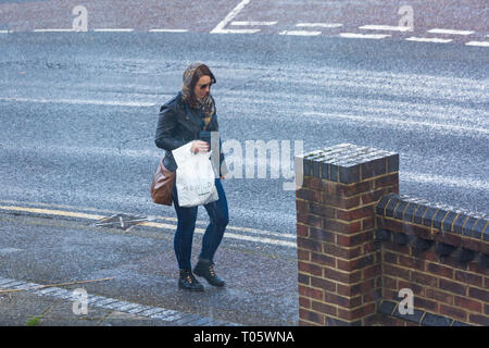 Bournemouth Dorset, Regno Unito. 17 mar 2019. Regno Unito: Meteo Meteo fredda con chicchi di grandine, come donna cammina lungo il marciapiede di bagnarsi. Credito: Carolyn Jenkins/Alamy Live News Foto Stock