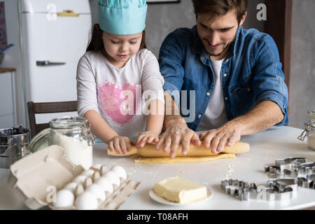 Padre e figlia piccola pasticceria da forno. Famiglia divertimento in cucina e tenetevi pronti per una festa. Foto Stock