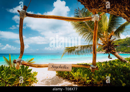 Incredibile scena tropicale con cornice di bambù sulla spiaggia di sabbia bianca contro il mare turchese. Vacanza in paradiso. Mahe Island, Seicelle Foto Stock