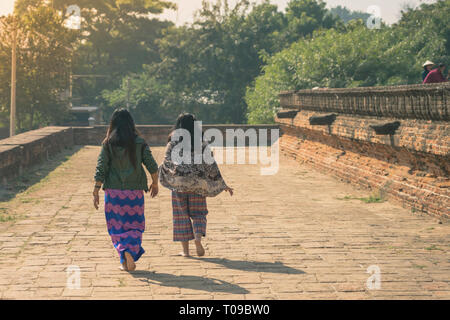 Backview femminile di turisti alla antica Pa Hto Taw Gyi Pagoda rovine a Mingun città vicino a Mandalay, Myanmar. Foto Stock