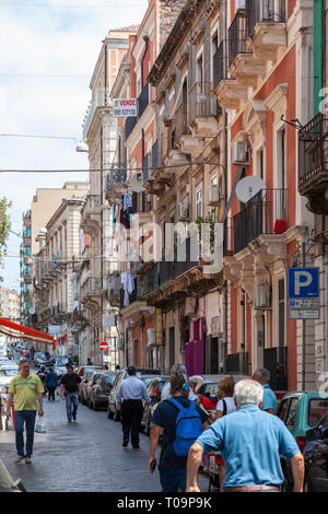 Una trafficata strada stretta a Catania, Siciy, Italia Foto Stock