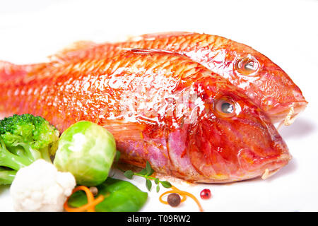 Due triglie e verdure su sfondo bianco Foto Stock