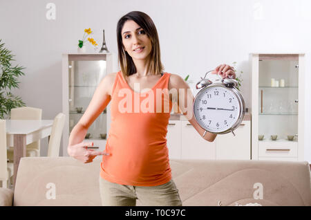 Giovane donna incinta a casa Foto Stock