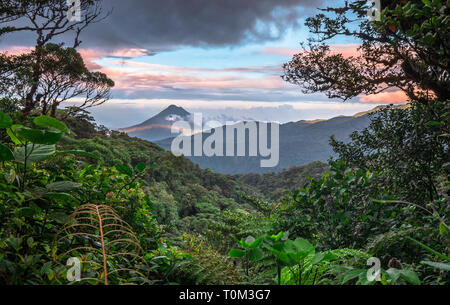 Volcan Arenal domina il paesaggio durante il tramonto visto da Monteverde, Costa Rica. Foto Stock