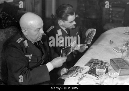 La Seconda Guerra Mondiale / La seconda guerra mondiale la propaganda, corrispondente di guerra della Luftwaffe (tedesco Air Force) Georg Schoedl, Airforce corrispondente di guerra Company, con un capitano (sinistra), guardando le fotografie, gennaio 1941, Additional-Rights-Clearance-Info-Not-Available Foto Stock