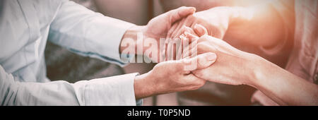 Sezione mediana del terapista tenendo le mani del paziente Foto Stock