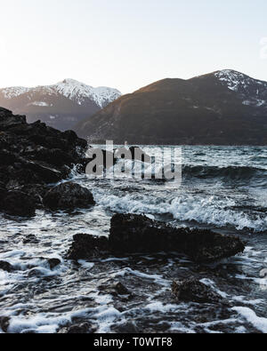 Sunset le onde a Porteau Cove, BC. Foto Stock