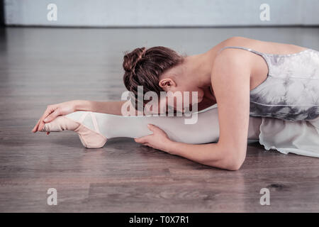 Grave giovane donna che lavorano per la sua flessibilità Foto Stock